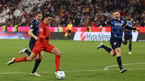 Bayern Munich's German midfielder #42 Jamal Musiala (2nd L) shoots to score the 4-2 during the German first division Bundesliga football match between FC Bayern Munich and Heidenheim in Munich, southern Germany, on 7 December 2024.