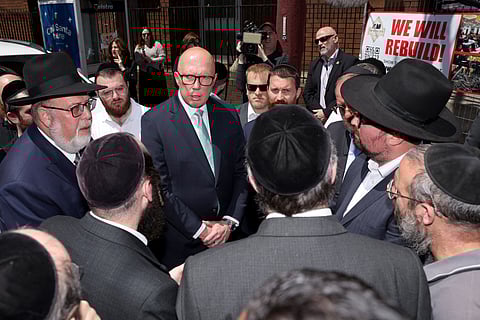 AUSTRALIA’s opposition leader Peter Dutton (center) speaks to members of the Jewish community outside the damaged Adass Israel Synagogue in the Melbourne suburb of Ripponlea on 9 December 2024. Australian police said on 9 December they are hunting for three suspects linked to a Melbourne synagogue blaze, which authorities have designated as a terrorist