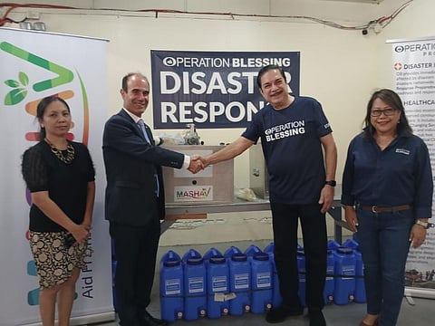 Israel Ambassador to the Philippines Ilan Fluss (left) shakes hands with Operation Blessing president and CEO Peter Kairuz during the turnover of water filtration devices to be distributed to displaced residents following the eruption of Mt. Kanlaon in Negros Occidental.
