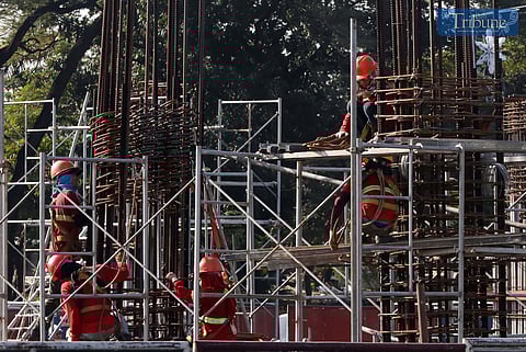 On Thursday, 12 December 2024, workers construct a post for the ongoing Metro Rail Transit (MRT-7) project at Philcoa, along Commonwealth Avenue in Quezon City, set to feature 12 stations and begin operations by the fourth quarter of 2025.