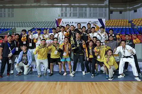 The UST men’s judo team celebrates its triumph in UAAP Season 87.