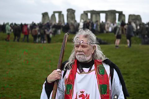 Druid, Arthur Pendragon look on as people gather to celebrate the pagan festival of 'Winter Solstice' at Stonehenge in Wiltshire in southern England on December 21, 2024. Followers of Druidism, celebrate the pagan solstice festival at the site each year.
