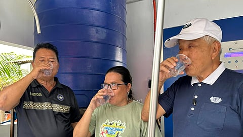Tubigon Mayor William R. Jao (left) and Tzu Chi Bohol deputy coordinator Joven Uy (right) drink potable water produced by the desalination facility in Bagongbanwa Island.