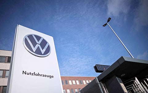A general view of the entrance of the commercial vehicle plant of German car manufacturer Volkswagen with its logo on a board reading ‘Commercial vehicles’ (Nutzfahrzeuge) is pictured on 20 December 2024 in Hanover, northern Germany. The crisis-wracked auto titan has been locked in bitter talks with unions since announcing in September that it was mulling the unprecedented step of shuttering plants in Germany.