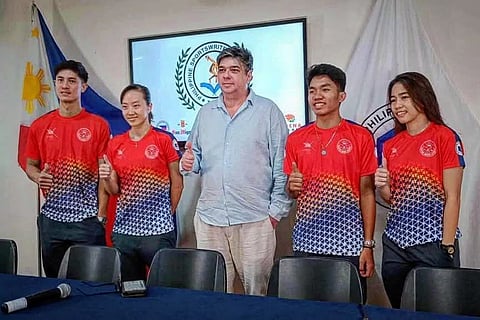 Malaysian coach Wee Wern Low (second from left) and Philippine Squash Academy Robert Bachmann strike a pose with players Reymark Begornia, Christopher Buraga and Jemyca Aribado.