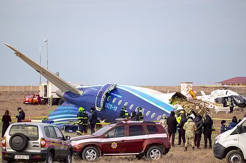 Emergency specialists work at the crash site of an Azerbaijan Airlines passenger jet near the western Kazakh city of Aktau on December 25, 2024. 
