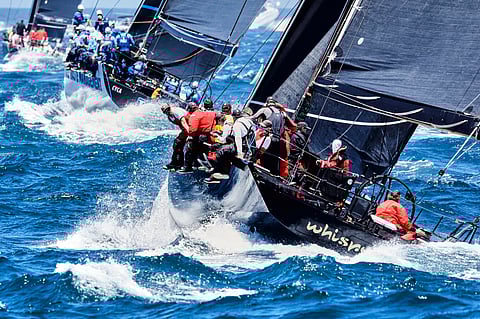 Sailors on board Whisper negotiate the treacherous waters at the start of the Sydney to Hobart race on Thursday at Sydney Harbour.