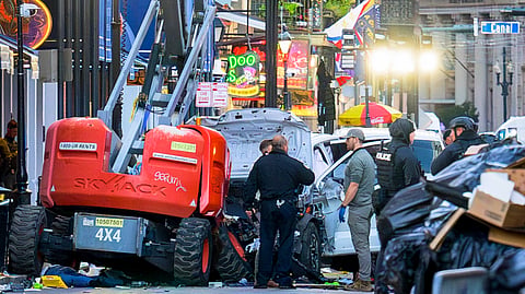 Police investigators surround the white Ford F-150 pickup truck that crashed into a work lift after allegedly driving into a crowd of New Year's revelers in the French Quarter of New Orleans, Louisiana, on 1 January 2025. At least 10 people were killed and 30 injured Wednesday when a vehicle plowed overnight into a New Year's crowd in the heart of the thriving New Orleans tourist district, authorities in the southern US city said.