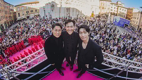 ‘Squid Game’s’ Hwang Dong-hyuk, Lee Jung-jae and Wi Ha-jun at the Piazza San Michele with fans on 31 October.