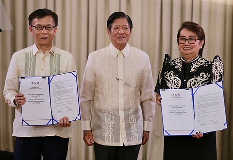(From left to right) Department of Migrant Worker Secretary Hans Leo Cacdac, President Ferdinand Marcos Jr., and Maritime Industry Authority Administrator Sonia Malaluan present the signed implementing rules and regulations of Republic Act 12021 or 'An Act Providing for the Magna Carta of Filipino Seafarers' in Malacanang Palace on Wednesday.