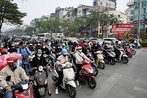 Vehicles wait at a red light at an intersection in Hanoi on 8 January, 2025.