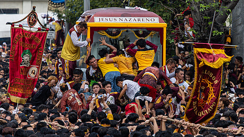 SACRIFICE AND FAITH: Catholics brave crowds and heat every 9 January to be near the image of the Black Nazarene during the Traslacion procession.
