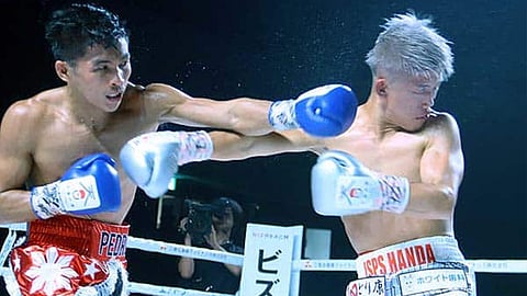 Pedro Taduran (left) smashes his way past Ginjiro Shigeoka in their IBF minimumweight title fight last year in Otsu City, Japan.