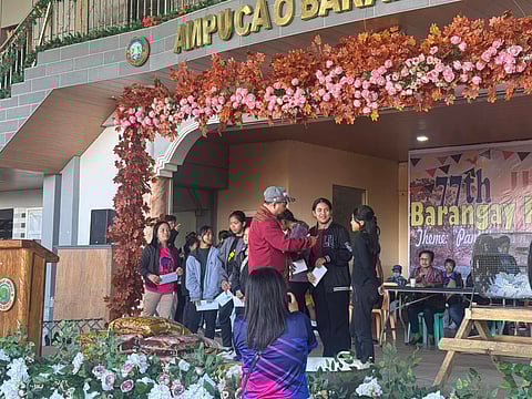 Students from Barangay Ampucao receive reward money for their academic excellence courtesy of Philex Mining Corp. 