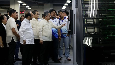 Comelec Chairman George Erwin Garcia shows ballots to the media on Monday, 6 January 2025, at the national printing office in Quezon City.