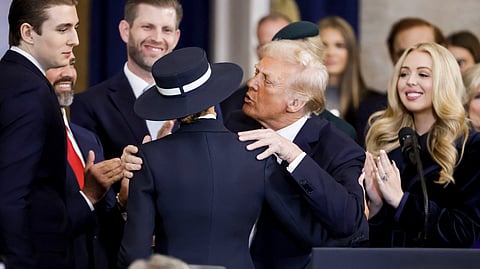 US President Donald Trump (2-R) with his wife First Lady Melania Trump (3-L) as well as his son Barron Trump (L), son Eric Trump (2-L) and daughter Tiffany Trump (R) after being sworn in during an inauguration ceremony in the rotunda of the United States Capitol on 20 January 2025 in Washington, DC. Donald Trump takes office for his second term as the 47th President of the United States.