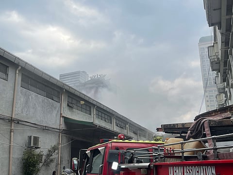 White smoke comes off from MM Lucky Multisales Warehouse in Barangay 254, Manila last Tuesday, 21 January
