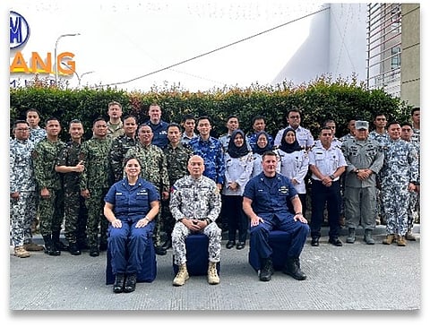 United States Coast Guard (USCG) Commander Christine Igisomar (leftmost, seated), Philippine Coast Guard (PCG) District Southeastern Mindanao Commander Commodore Rejard V. Marfe (center, seated), and USCG Team Lead Lieutenant Dana Schmitt (rightmost, seated) pose for a group photo with participants during the opening ceremony of the Boarding Officer Course in Davao City.  
