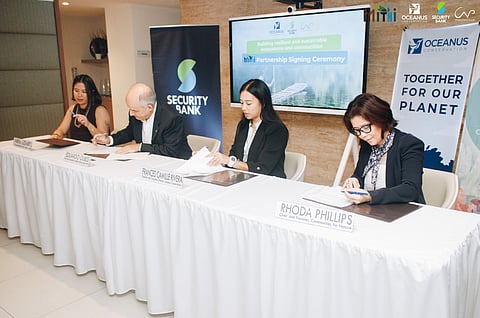 Security Bank head of sustainability Nikki Lizares (left) and chief financial officer Eduardo Olbes, together with Frances Camille Rivera, founder and executive director of Oceanus Conservation, and Rhoda Phillips, chair and founder of Communities for Nature, sign the memorandum of agreement on the Mangrove-Based Initiatives for Thriving Habitats and Inclusive Communities or MITHI. 