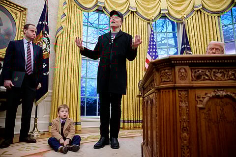 TESLA and SpaceX CEO Elon Musk, accompanied by US President Donald Trump (right), his son X Musk, and White House staff secretary Will Scharf (left), speaks during an executive order signing in the Oval Office at the White House on 11 February 2025 in Washington, DC. 
