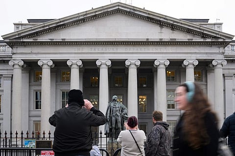 People take pictures of the US Treasury in Washington, DC, on February 6, 2025. Opponents to US President Donald Trump say he allowed Elon Musk — the world’s richest man and a major government contractor — to break the law by accessing US Treasury payment systems that send out trillions of dollars and hold a welter of sensitive personal data. 