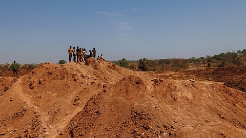 People look at an artisanal gold mine in Danga on 31 January 2025, the following day after a landslide killed at least 10 people and left many others missing.