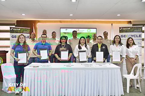 Officials present the signed tripartite memorandum of agreement for the Adopt-A-Community Program at the office of the Carmona City mayor in Cavite on 8 February. They are Engr. Samuel O. Manlosa Jr., chief sustainability officer of Holcim Philippines and senior vice president and head of Geocycle (2nd from left); Carmona City Mayor Dr. Dahlia A. Loyola (3rd from left); Dr. Shirlyn C. Reyes, Universal Robina Corp. vice president for global quality, environment, health and safety and sustainability (4th from left); and City Environment and Natural Resources Officer Rommel Peneyra (3rd from right).