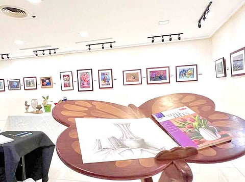 The exhibit is interactive as it invites visitors to sketch or draw the still life objects on display in the exhibit.