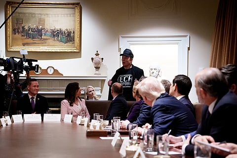 WASHINGTON, DC - FEBRUARY 26: Tesla and SpaceX CEO Elon Musk, head of the Department of Government Efficiency (DOGE), displays his t-shirt that reads "Tech Support" as he speaks during a Cabinet meeting held by U.S. President Donald Trump at the White House on 25 February  2025 in Washington, DC. Trump is holding the first Cabinet meeting of his second term. 