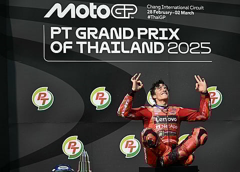 Ducati Lenovo's Spanish rider Marc Marquez celebrates on the podium after winning the MotoGP Thailand Grand Prix at the Buriram International Circuit in Buriram on 2 March 2025.
