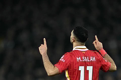Liverpool's Egyptian striker #11 Mohamed Salah celebrates scoring the team's second goal during the English Premier League football match between Everton and Liverpool at Goodison Park in Liverpool, north west England on February 12, 2025.