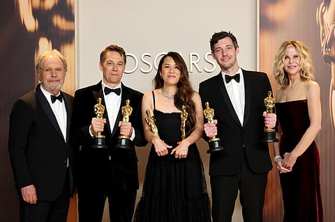 (L-R): Sean Baker, Samantha Quan, and Alex Coco, winners of the Best Picture for “Anora”, pose in the press room with Billy Crystal and Meg Ryan during the 97th Annual Oscars at Ovation Hollywood on March 02, 2025 in Hollywood, California