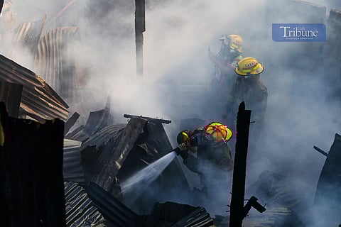 Residents and firefighters extinguish a fire that hit a residential community in Barangay Ususan, Taguig City, on the 4th day of Fire Prevention Month, 4 March 2025. The fire, which prompted the raising of the 4th alarm at 2:45 PM, was declared under control at 3:27 PM.