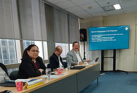 Malayan Insurance chief operating officer Denden Tesoro (lady in black suit) and Philippine Insurers and Reinsurers Association executive director Michael Rellosa (gentleman in gray suit) discuss outlook for the non-life insurance industry on 5 March 2025 at BPI-Philam Life Tower in Makati City. 
