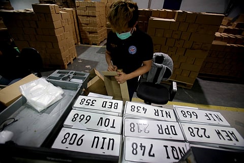 PERSONNEL of the Land Transportation Office repack newly made vehicle license plates at the Plate Making Facility at the LTO Headquarters in Quezon City in this file photo. The LTO hopes to resolve the plate license backlog.