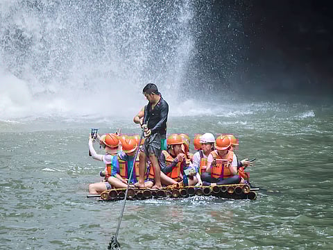 Tourists get wet in Pagsanjan Falls, Laguna as part of the Department of Tourism’s Philippine Experience Program tour. 