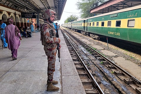 Paramilitary soldier stands guard at a railway station in the Sibi district of southwestern Balochistan province on 12 March 2025, during a security operation against militants a day after they hijacked a passenger train. 
