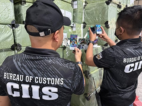 Personnel of BoC-Customs Intelligence and Investigation Services-Manila International Container Port inspect some illicit vape products that are part of the seized P1.18 billion worth of contrabands in a raid in Valenzuela City warehouse on Thursday.