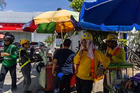 Construction workers take a break under the shade of umbrellas and enjoy cold refreshments from street vendors in Quezon City on Friday, 14 March 2025.

While this year’s dry season is not expected to surpass last year’s record-breaking temperatures, PAGASA warns that the heat index could still soar to 48 to 50 degrees Celsius between late April and early May.