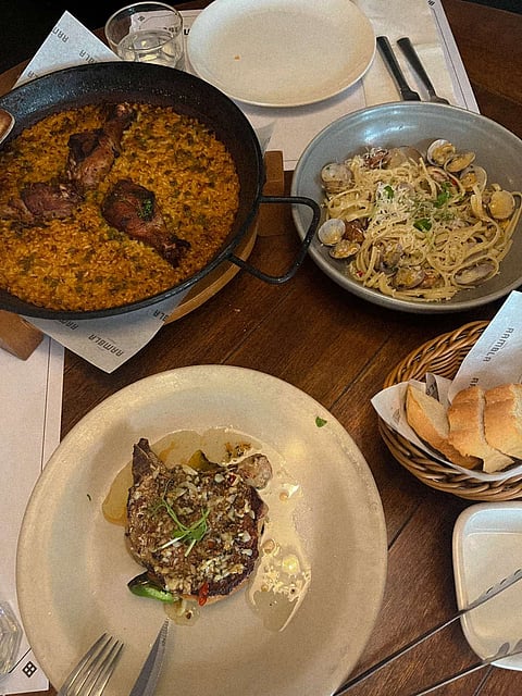 Pollo paella, linguine vongole, and pork chop