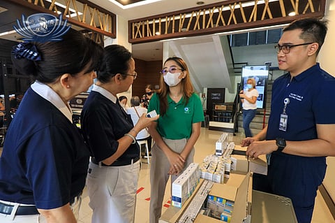 Zoey Velasquez (2nd from right), sales agent of pharmaceutical firm Santen Philippines, shows donated eye drops to volunteers of Tzu Chi Eye Center during the annual glaucoma lecture as part of the observance of World Glaucoma Week on 13 March in Sta. Mesa, Manila.