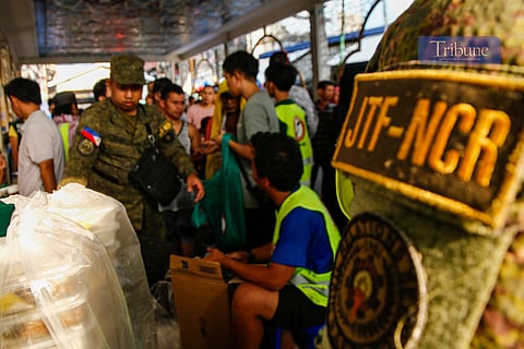 Joint Task Force NCR of the Armed Forces of the Philippines distributes food packs to the Muslim community in Quiapo, Manila, on 16 March 2025, in time for 'iftar.' The food packs, prepared by the AFP's Mobile Kitchen and volunteers, were offered in solidarity with the Muslim community during Ramadan.