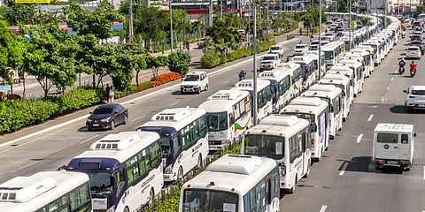 Rows of modern Public Utility Vehicles line the road marking a shift towards cleaner and more efficient public transportation in the Philippines. 