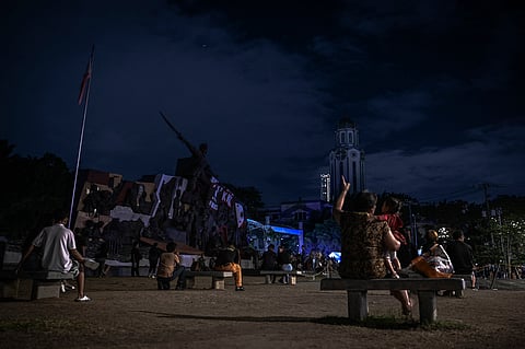 The Manila Clock Tower is pictured after its lights are turned off to mark the Earth Hour environmental campaign in Manila on March 23, 2024.