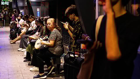 People wait at a bus station in Bangkok on 28 March 2025, after an earthquake. A huge earthquake hit Myanmar and Thailand on 28 March, killing more than 150 people and injuring hundreds, with dozens trapped in collapsed buildings and the death toll expected to rise.