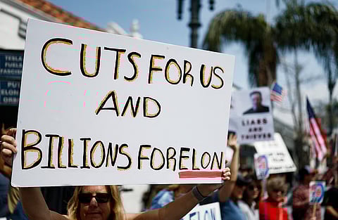 PASADENA, CALIFORNIA - Protesters demonstrate against Tesla CEO Elon Musk’s Department of Government Efficiency (DOGE) initiatives during a nationwide “Tesla Takedown” rally outside a dealership on 29 March 2025 in Pasadena, California. Protesters in more than 30 states nationwide are demonstrating against the Department of Government Efficiency during what organizers are calling a global day of action.

