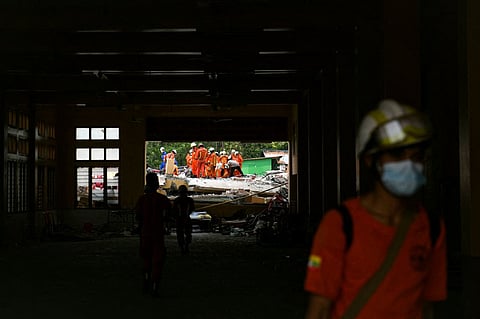Rescue workers search for victims trapped in the rubble of a damaged temple in Mandalay on March 30, 2025, two days after an earthquake struck central Myanmar. Residents scrambled desperately through collapsed buildings Sunday searching for survivors as aftershocks rattled the devastated city of Mandalay, two days after a massive earthquake killed more than 1,600 people in Myanmar and at least 17 in neighbouring Thailand.