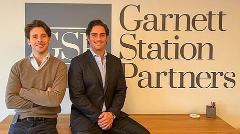 Matt Perelman and Alex Sloane, co-founders of Garnett Station Partners, at their shared office desk where they've built a multibillion-dollar private equity firm from the ground up.