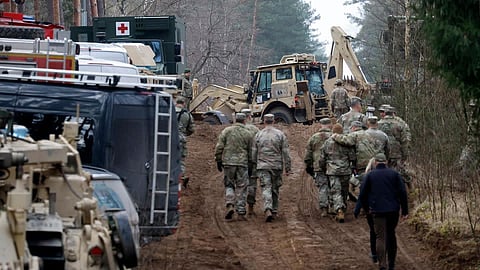 Military personnel work at the site of a rescue operation for missing US soldiers at Pabrade training ground, in Lithuania, on March 28.  