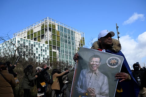 [FILE PHOTO] A man holds a portrait of former Philippines president Rodrigo Duterte in front of the International Criminal Court (ICC) where he will be appearing, in The Hague on March 14, 2025. Philippine ex-president Rodrigo Duterte was expected to make his first appearance at the International Criminal Court on 14 March to face crimes against humanity charges over his deadly narcotics crackdown. The 79-year-old was set to appear before judges for a short hearing where he is to be informed of the crimes he is alleged to have committed, as well as his rights as a defendant.